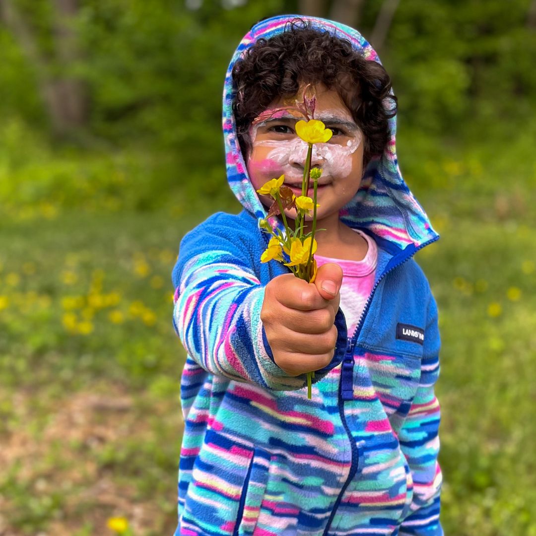 child collecting flowers